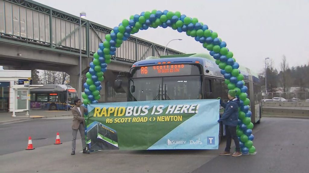 An R6 Rapid Bus arrives at a SkyTrain Station in Surrey