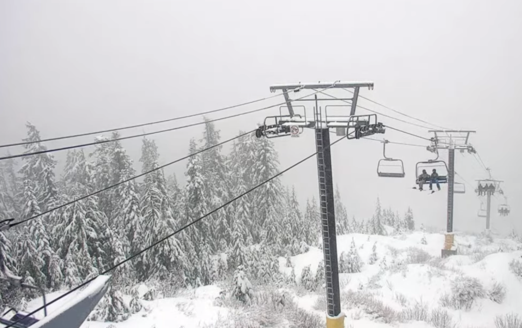 Snow falls over a ski lift at Cypress Mountain on Friday, Jan. 5, 2024