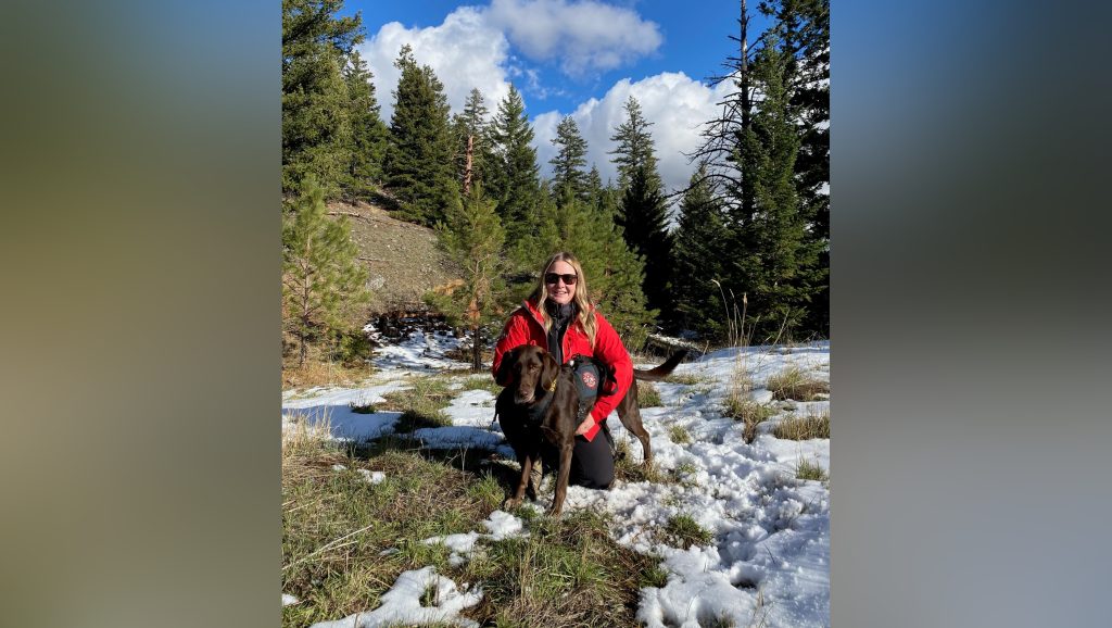 Carly Trobridge crouches with her canine search partner, Hazel. Together, they're part of Nanaimo Search and Rescue