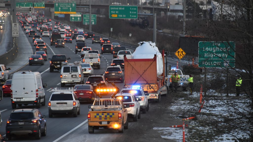 Police and Commercial Vehicle Safety Enforcement vehicles have an oversized truck transporting a helicopter pulled over on Highway 1 after the Gilmore overpass was hit on Monday January 15, 2024.