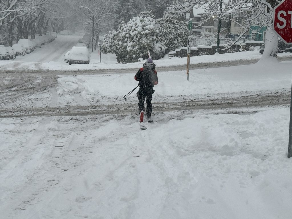 A skier, Joel, takes advantage of Wednesday's snowstorm to get around in Metro Vancouver.