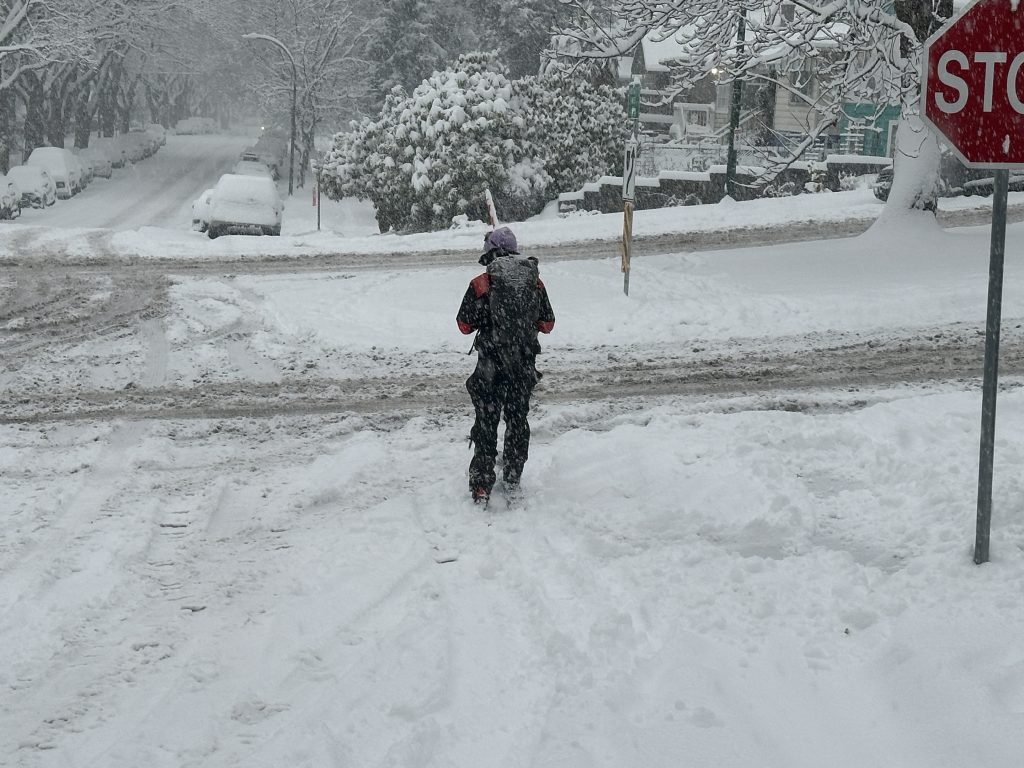 A skier, Joel, takes advantage of Wednesday's snowstorm to get around in Metro Vancouver