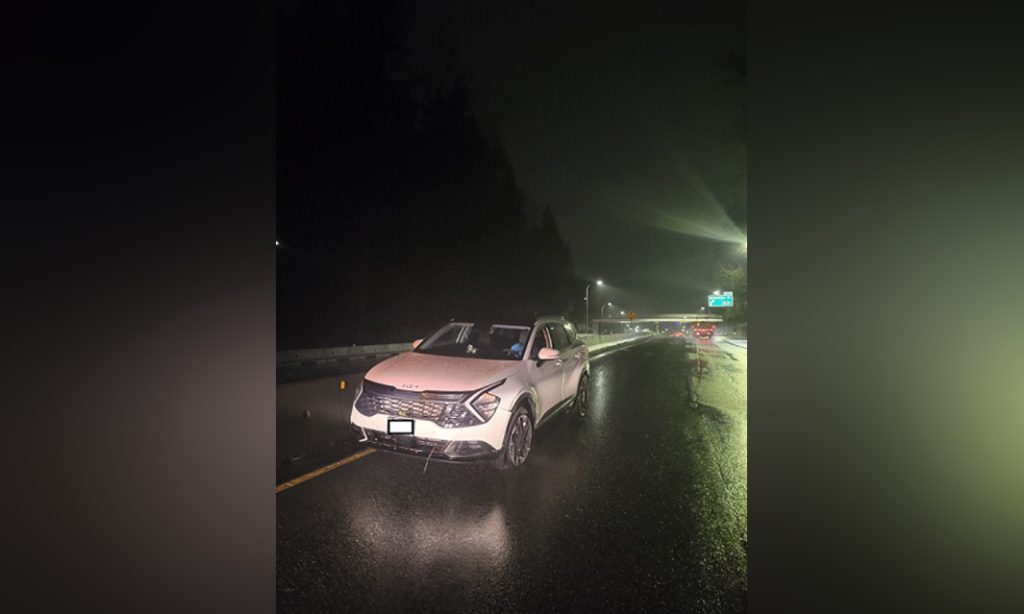 A white Kia SUV is pictured facing the wrong way on Highway 1 in North Vancouver. The RCMP says the driver was issued a 90-day prohibition after she failed a breathalyzer