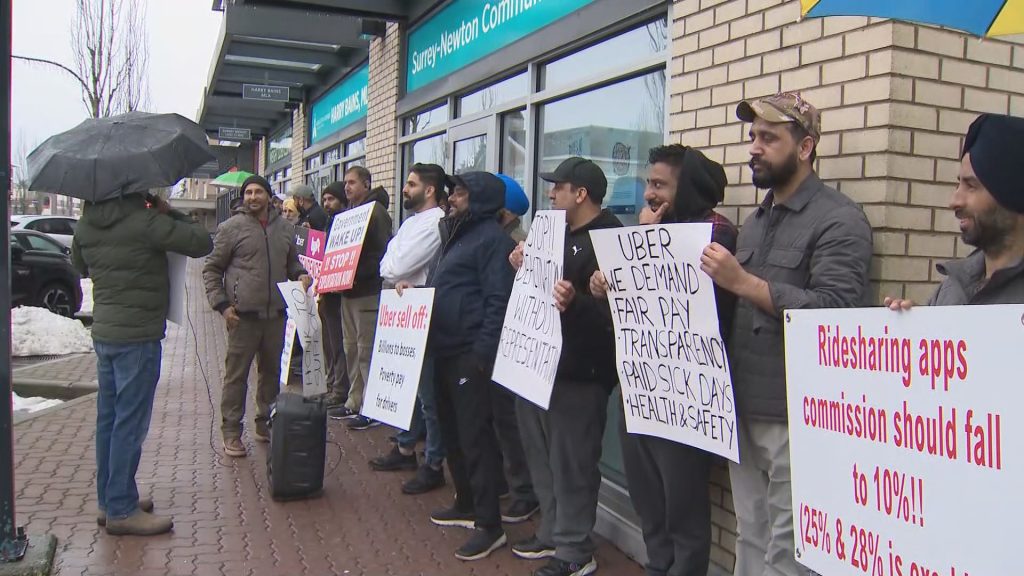 Uber and Lyft drivers protest outside of B.C. Labour Minister Harry Bains office on Tuesday January 24, 2024