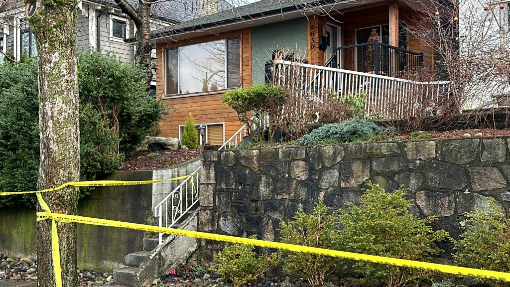A home sits behind police tape in Vancouver