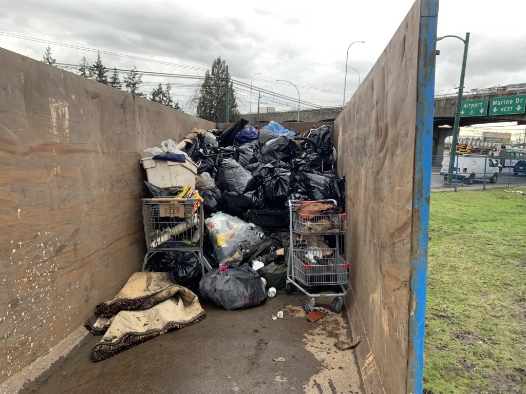 Belongings from an encampment along SW Marine Drive near Oak Street in Vancouver are pictured inside a container on Feb. 1, 2024.