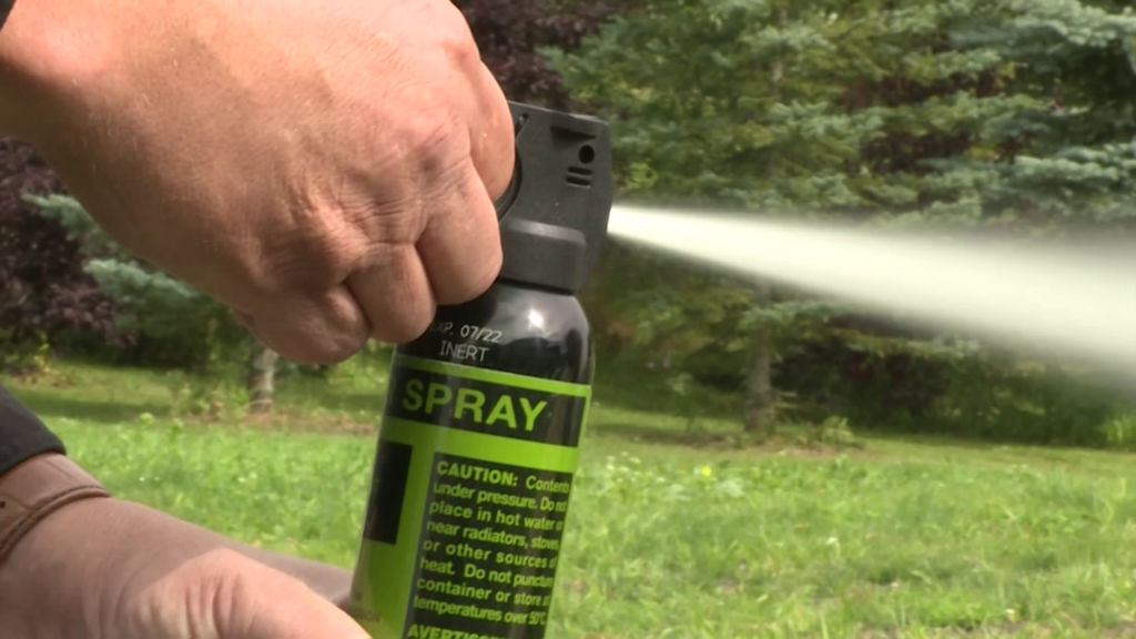 A bear spray canister being deployed