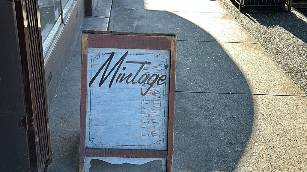 A sign for Mintage Mall on the sidewalk outside the building the business is located in along East Broadway near Kingsway in Vancouver's Mount Pleasant neighbourhood.