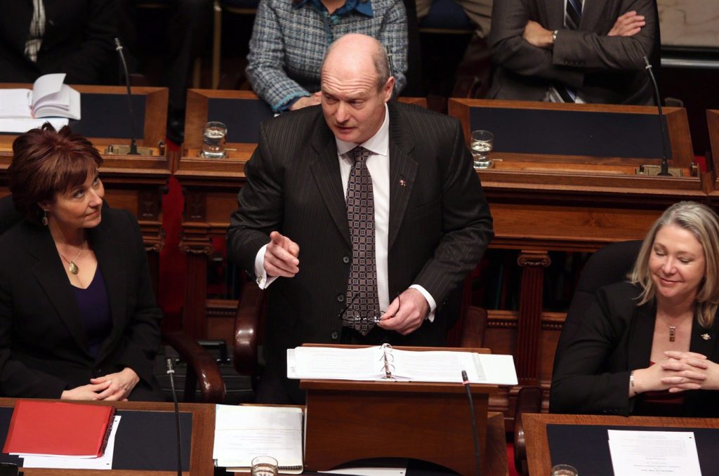 FILE - Then B.C. Finance Minister Mike de Jong, tables the budget in the Legislative Assembly in Victoria, B.C., in a February 17, 2015, file photo. THE CANADIAN PRESS/Chad Hipolito, File