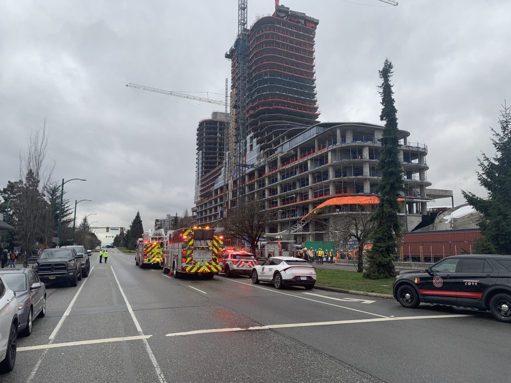 First responders and construction workers at Oakridge Mall in Vancouver on Feb. 21, 2024, after a crane incident at a construction site.