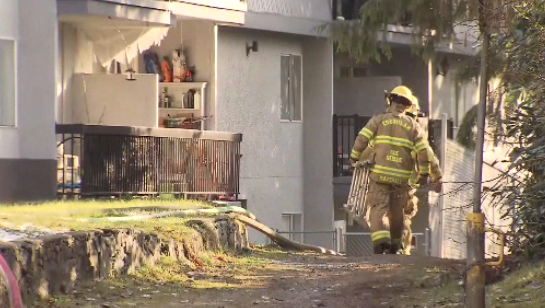 Coquitlam firefighters enter an apartment building after an early morning blaze on March 7, 2024