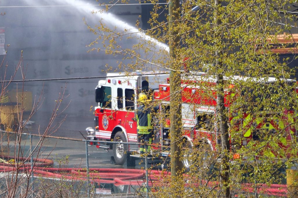 Firefighters battle fire at a Delta mill for hours, on Alaska Way along the Fraser River, just off Surrey Fraser Docks, early Sunday morning.