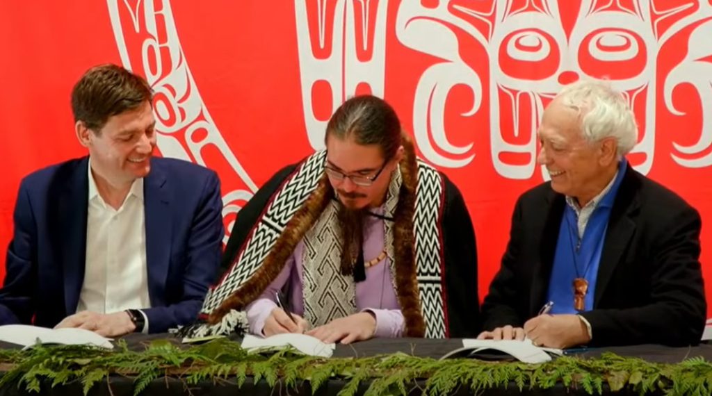 Premier David Eby, Haida Nation President Gaagwiis Jason Alsop, and Minister of Indigenous Relations and Reconciliation Murray Rankin sign the historic Gaayhllxid • Gíhlagalgang “Rising Tide” Haida Title Lands Agreement on Sunday, April 14, 2024