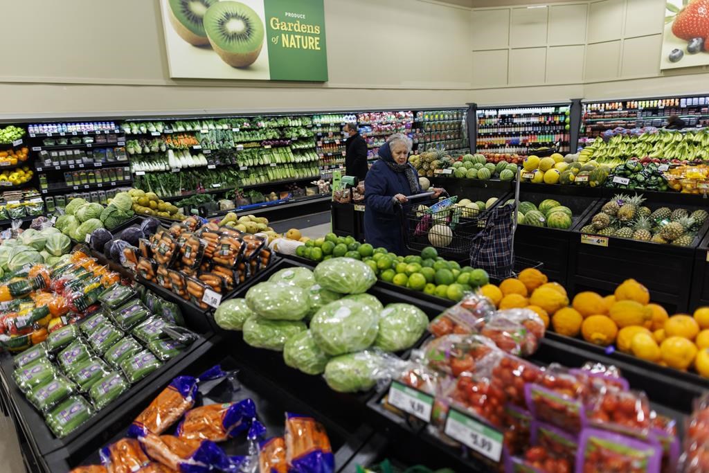 A customer walks through the produce section at a grocery store In Toronto on Friday, Feb. 2, 2024. A new report predicts that grocery inflation will fall below two per cent by the spring and stay roughly between one and two per cent for the rest of 2024. THE CANADIAN PRESS/Cole Burston