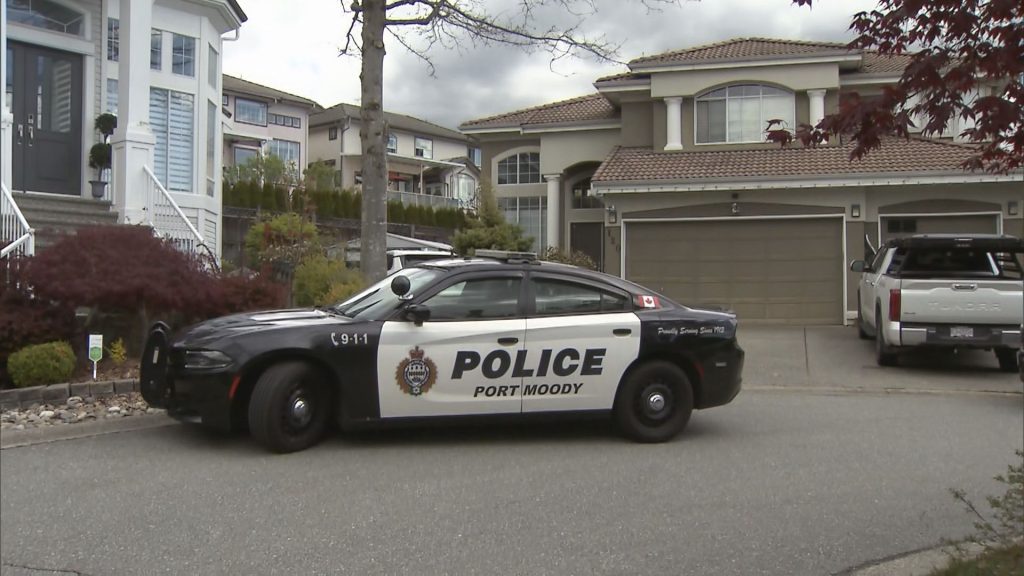 A Port Moody Police vehicle sits outside some homes in the Heritage Woods neighbourhood