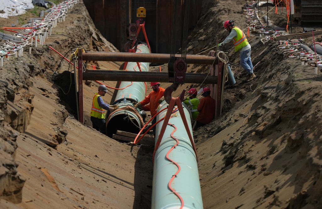 Workers lay pipe during construction of the Trans Mountain pipeline in Abbotsford, B.C., on Wednesday, May 3, 2023. THE CANADIAN PRESS/Darryl Dyck