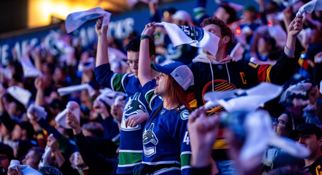 Fans celebrating as they watch the Vancouver Canucks