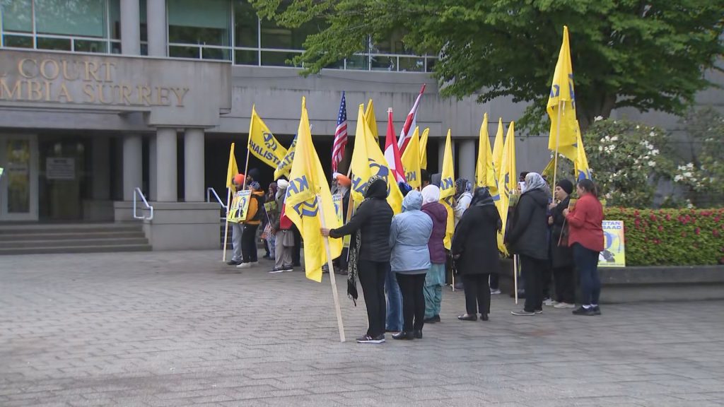 A group gathered outside Surrey Provincial Court on Tuesday May 7, 2024, as three men accused in the killing of Hardeep Singh Nijjar appeared before a judge. 