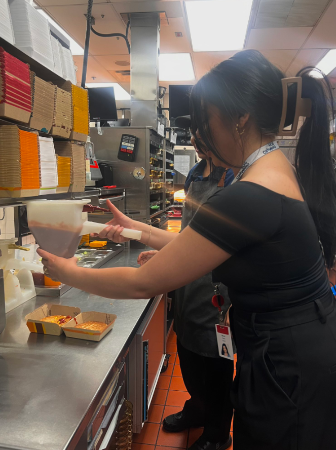 CityNews Anchor Maria Vinca helps make burgers at a McDonald's in Vancouver for McHappy Day 2024.