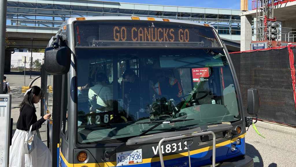 A bus in Vancouver displays 'GO CANUCKS GO' on the front to show the team support during the 2024 playoffs.