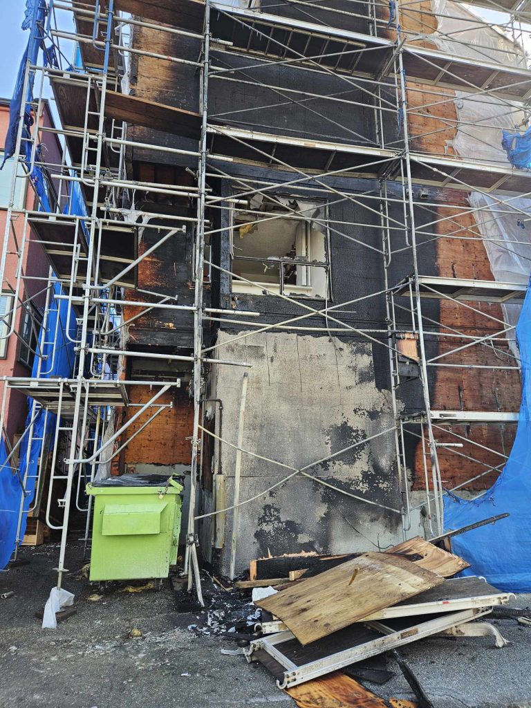 Damage to the side of an apartment building in Vancouver's West End neighbourhood after a fire the morning of Monday, May 20, 2024.