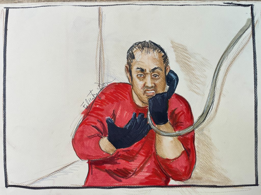 Courtroom drawing of Ali speaking into a handset.