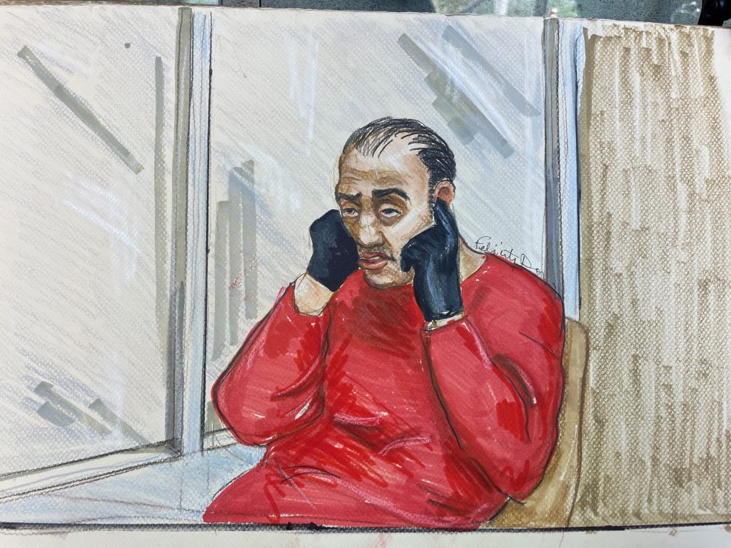 Courtroom drawing of Ali plugging his ears