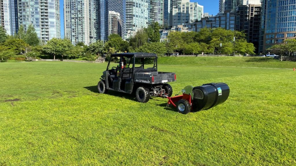 The pooper scooper device pulled behind a small utility vehicle in David Lam Park