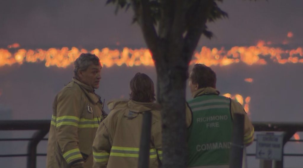 A massive fire is seen on an inactive rail trestle between Richmond and Vancouver along the Fraser River next to the Oak Street Bridge on Thursday June 20, 2024. (CityNews Image)