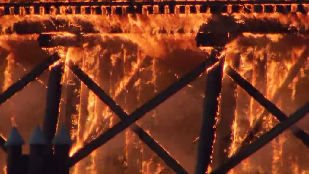 A massive fire is seen on an inactive rail trestle between Richmond and Vancouver along the Fraser River next to the Oak Street Bridge