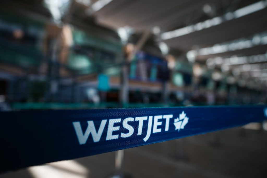 A WestJet logo is seen in the domestic check-in area at Vancouver International Airport, in Richmond, B.C., on May 19, 2023. THE CANADIAN PRESS/Darryl Dyck