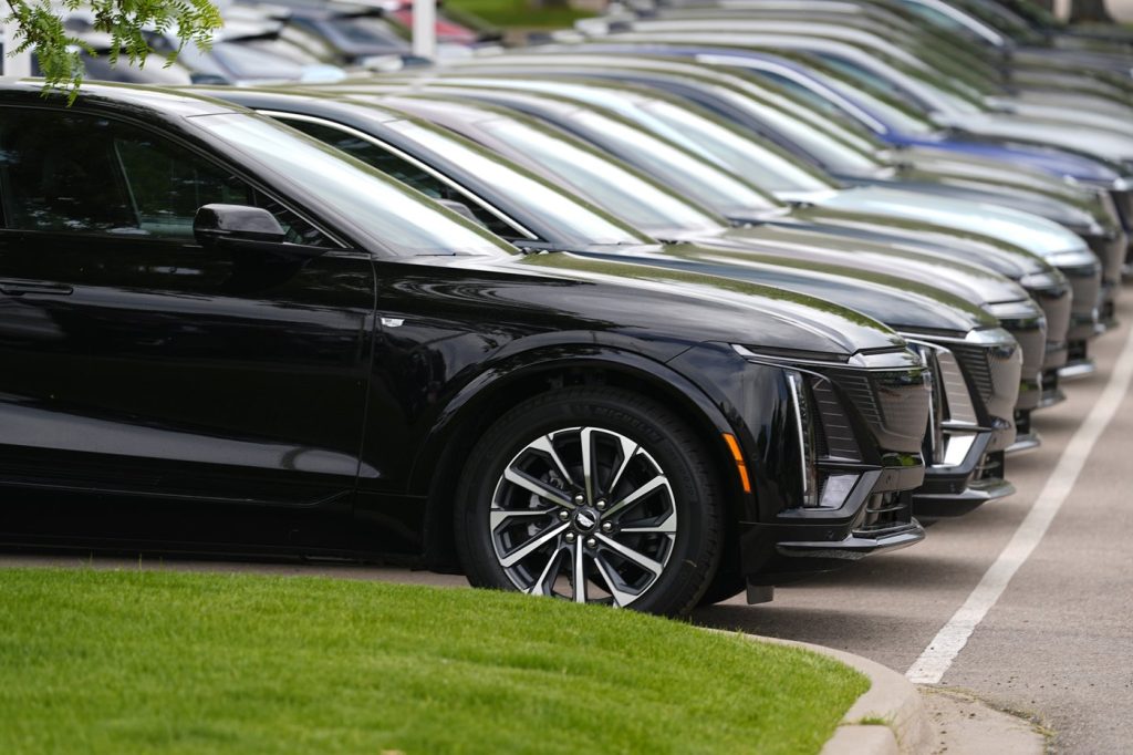 A line of cars parked at a dealership