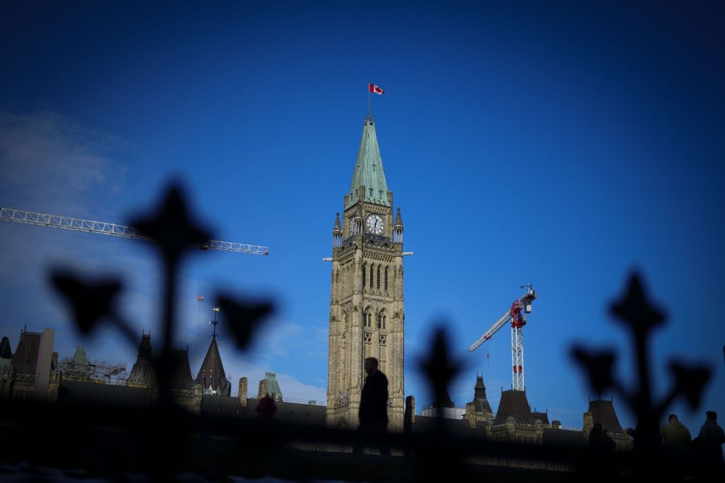 A person makes their way past the Peace Tower on Parliament Hill in Ottawa on Tuesday, Feb. 13, 2024. Liberal MP Ken McDonald says he won't run in the next federal election.