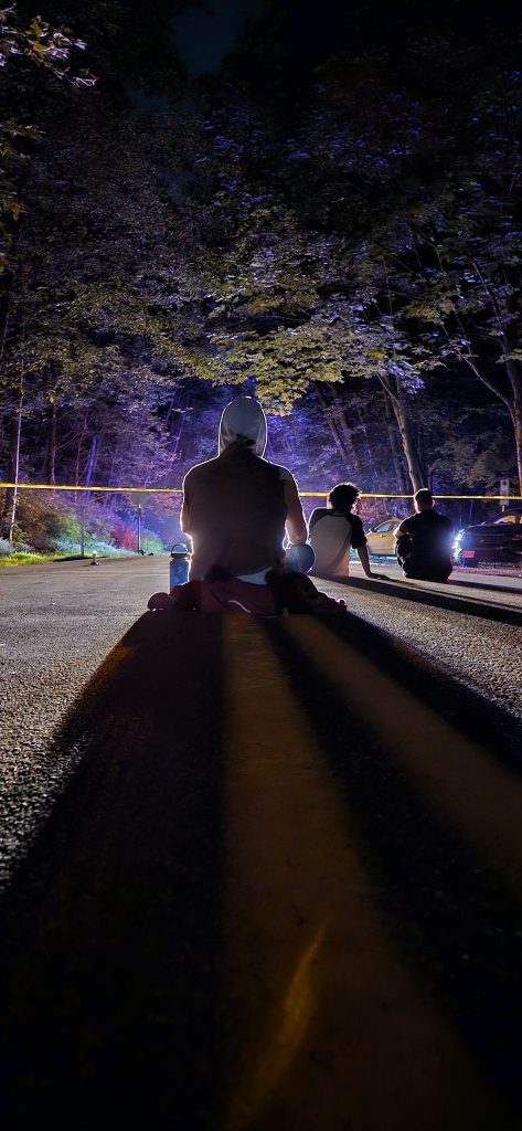 People sitting near the scene of the crash