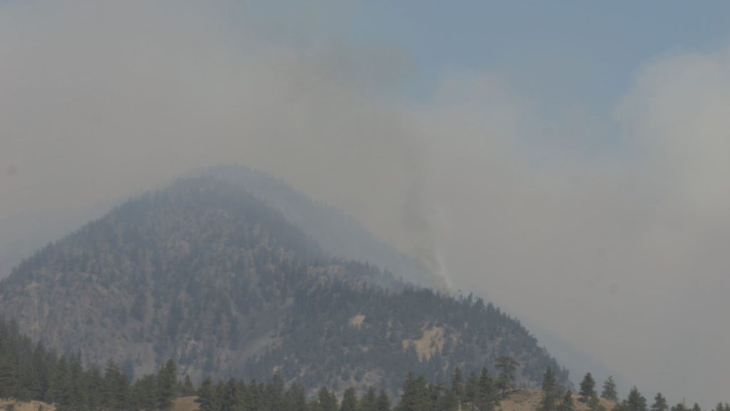 A wildfire is seen in the distance from Spences Bridge