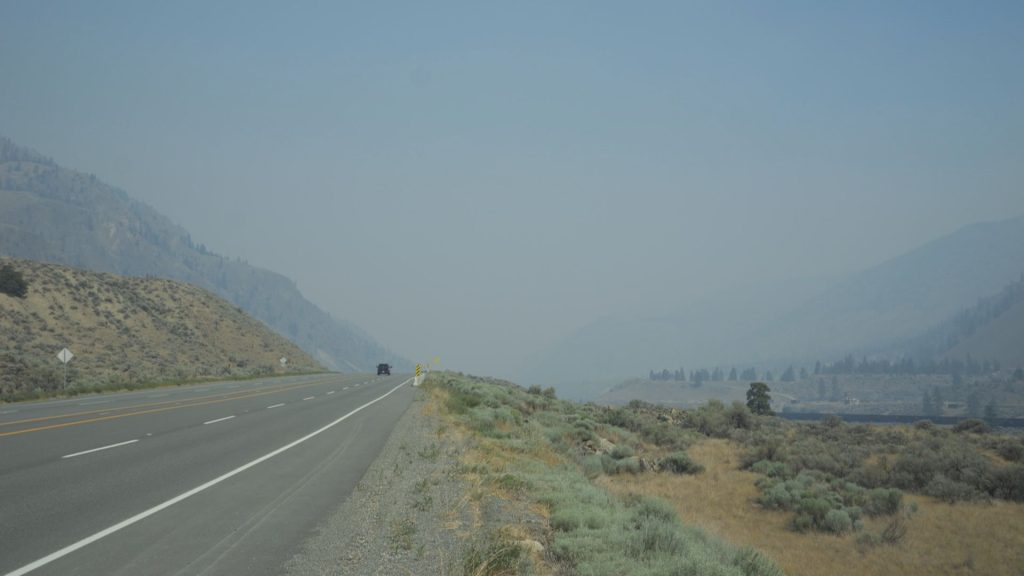 A wildfire is seen in the distance from Spences Bridge