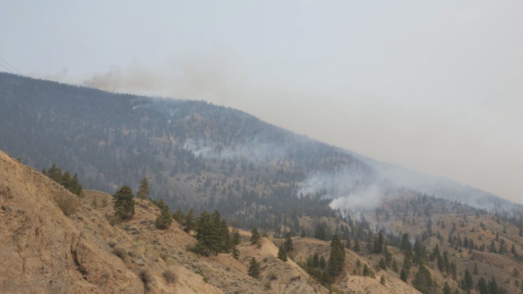 Smoke from the Shetland Creek wildfire rises next to Highway 1 near Spence Bridge