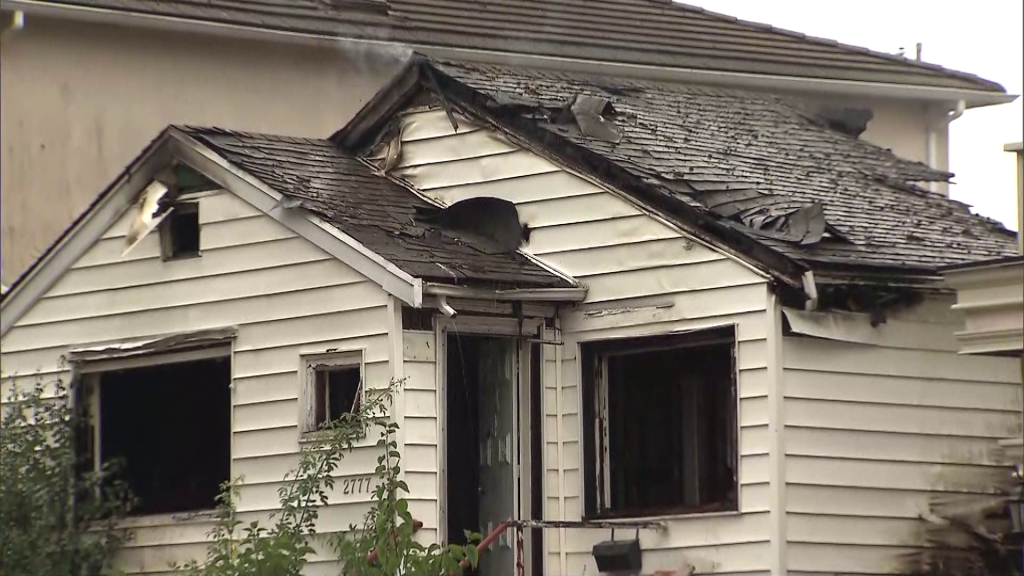 Vancouver Fire Rescue crews work on a fire on E 27th Avenue near Kaslo and Slocan