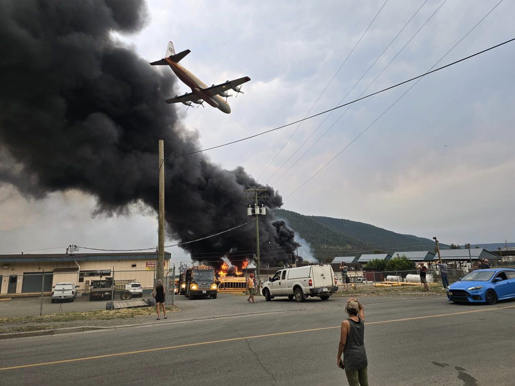 A BC Wildfire Service bomber flies over Williams Lake Sunday after a wildfire sparked in the city. (Credit: Spencer Stratton)