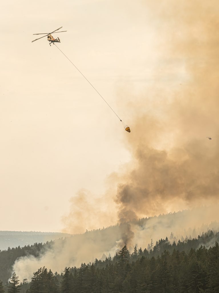 The Shetland Creek wildfire being actioned by a helicopter on Sunday July 21, 2024.