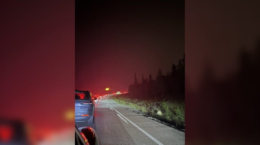 A long line of vehicles on the highway at night