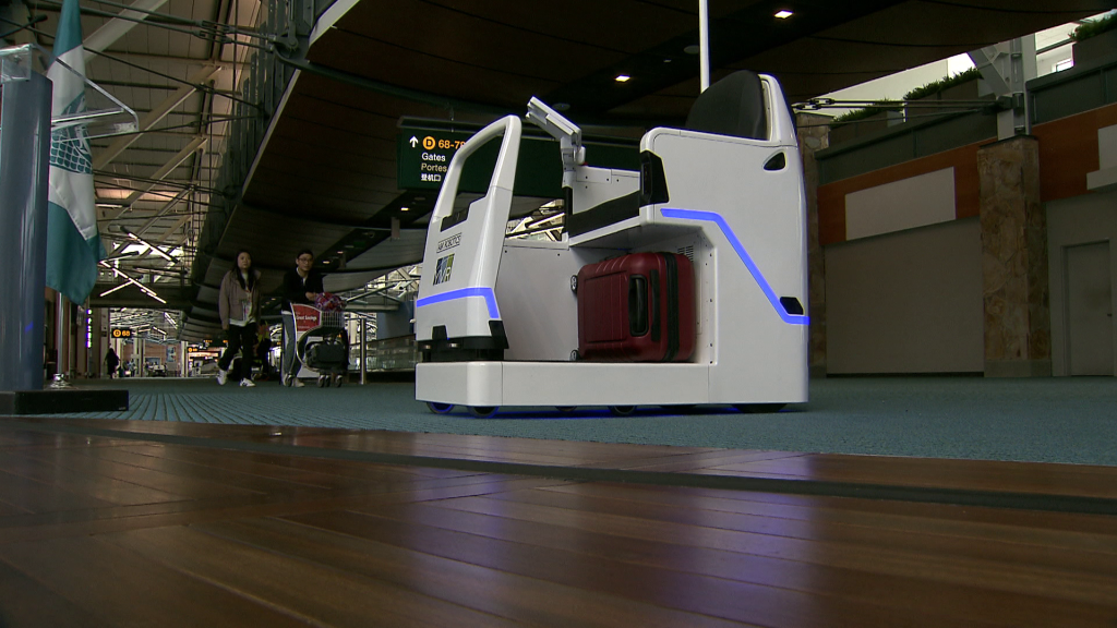 A white mobility scooter robot pictured at the airport