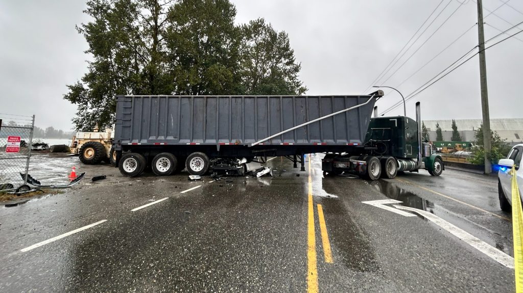 A Volkswagon Jetta crushed beneath a tractor trailer