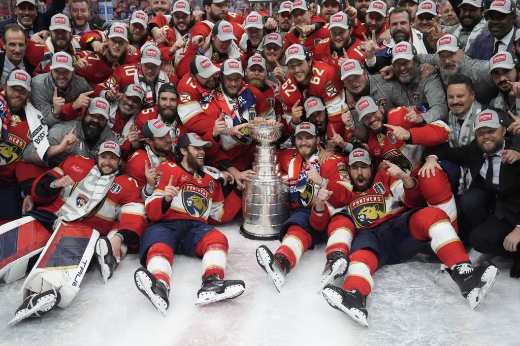 The Florida Panthers team poses with the Stanley Cup trophy after defeating the Edmonton Oilers in Game 7 of the NHL hockey Stanley Cup Final, Monday, June 24, 2024, in Sunrise, Fla. The Panthers defeated the Oilers 2-1.