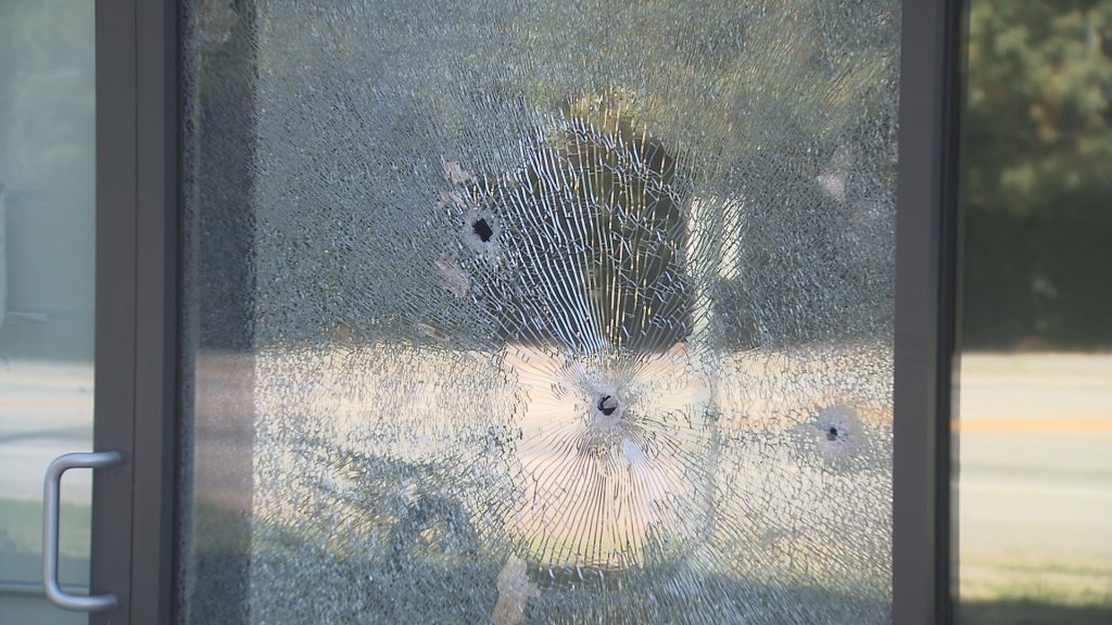 Bullet holes are seen in a vacant business.