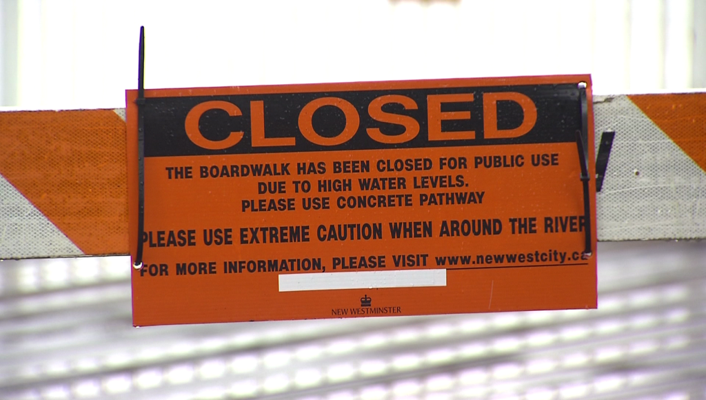 A closure sign on the quayside boardwalk in New Westminster