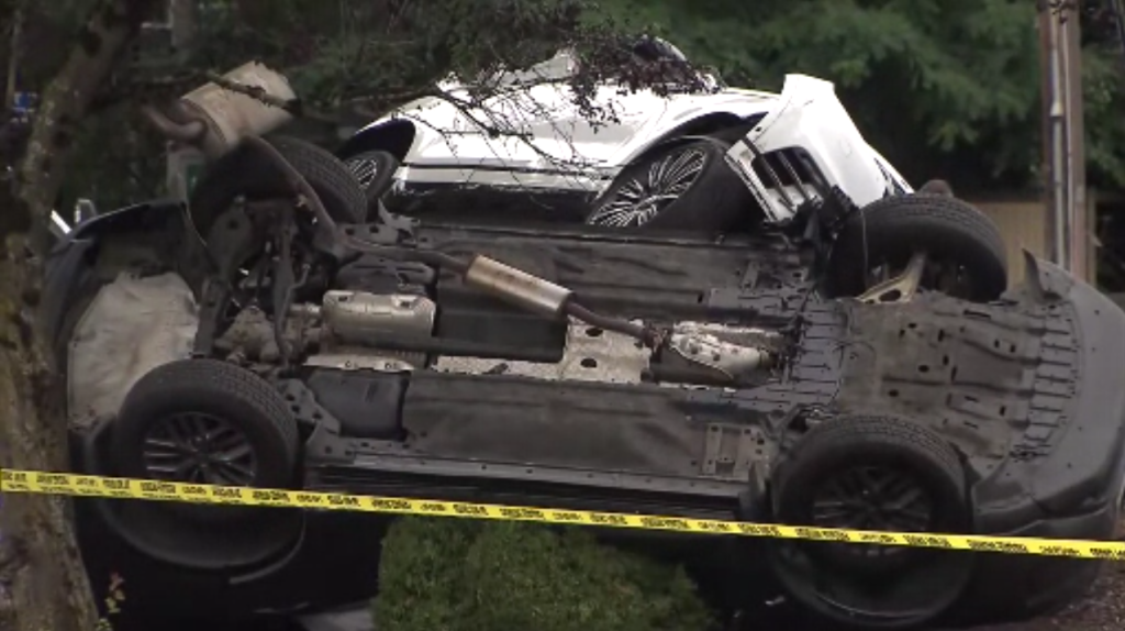 A rolled over vehicle and another vehicle involved in a crash are blocked by police tape