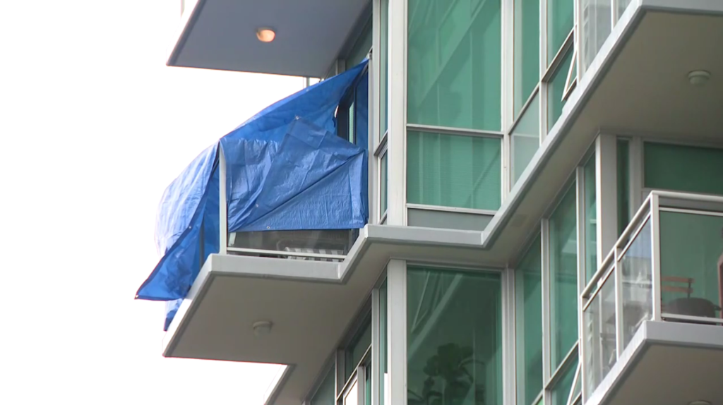 Tarps can be seen covering a balcony on East Esplanade Avenue in North Vancouver