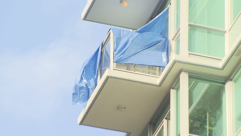 Tarps can be seen covering a balcony on East Esplanade Avenue in North Vancouver after a fatal incident on Aug. 20, 2024.