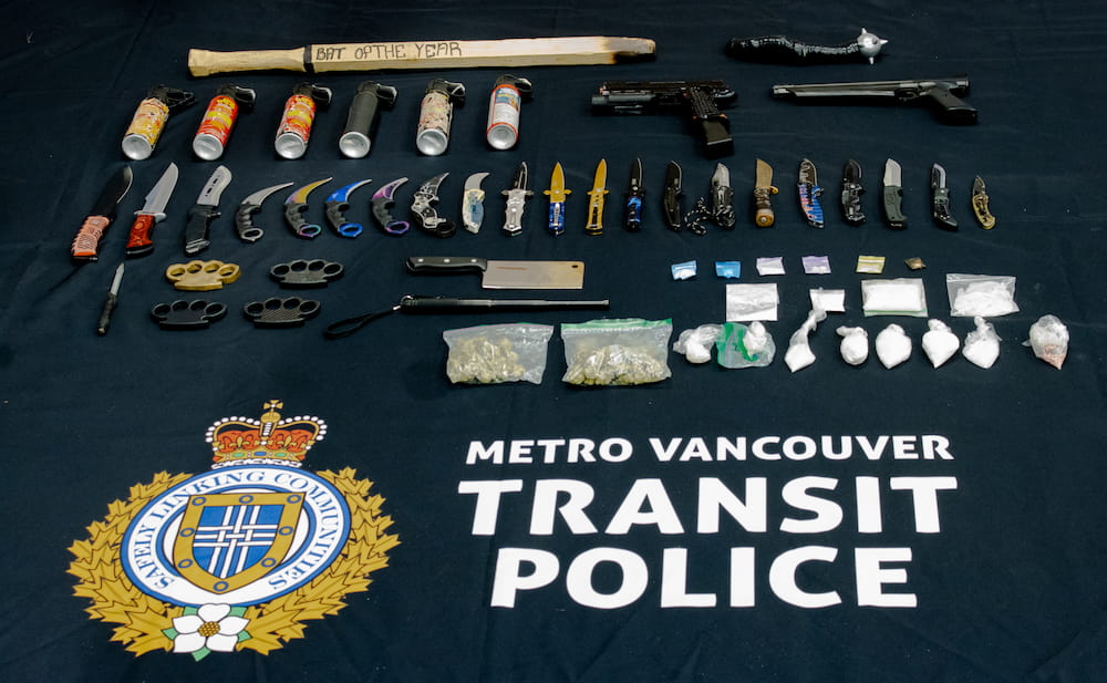 Weapons and drugs seized by police laid out on a table